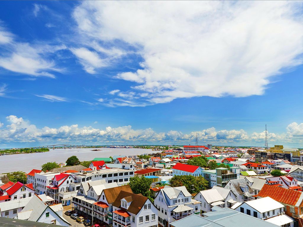 Aerial view of Paramaribo, Suriname, with colorful rooftops and the Suriname River